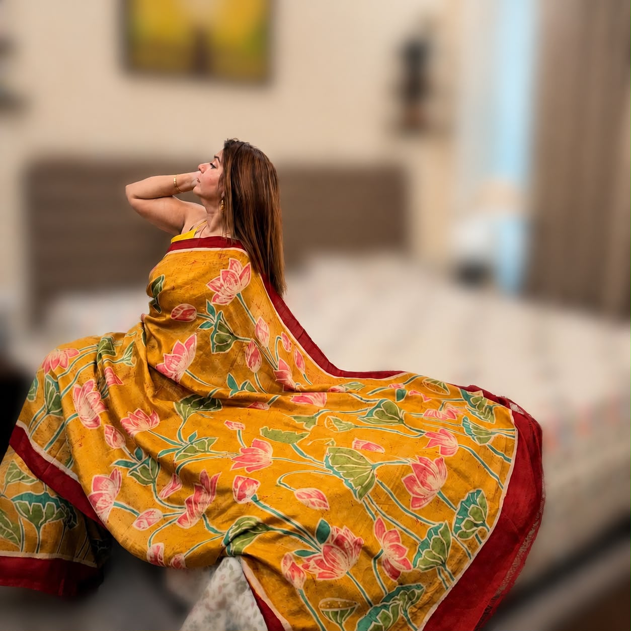 Praneeta Sharma displaying a yellow hand-painted lotus saree